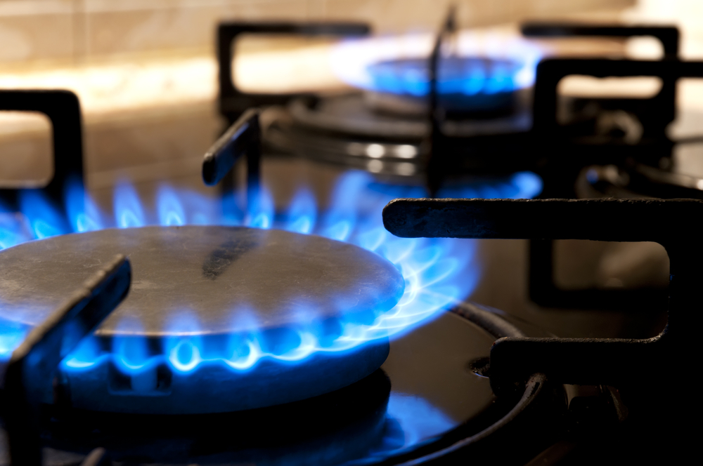 Black gas stove and two burning flames close-up